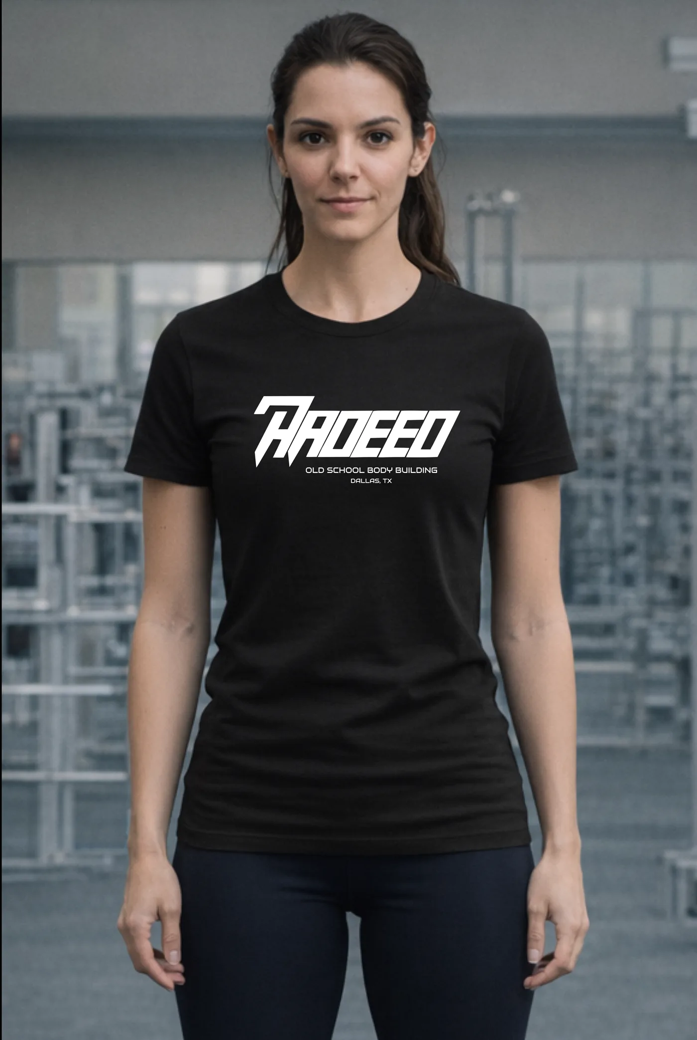 Iron Core Tee in black, worn by a woman on the gym floor